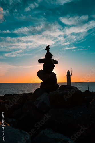 A pile of rocks and a lighthouse