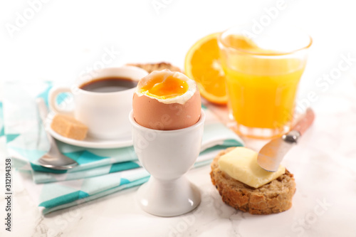 boiled egg, orange juice and coffee cup