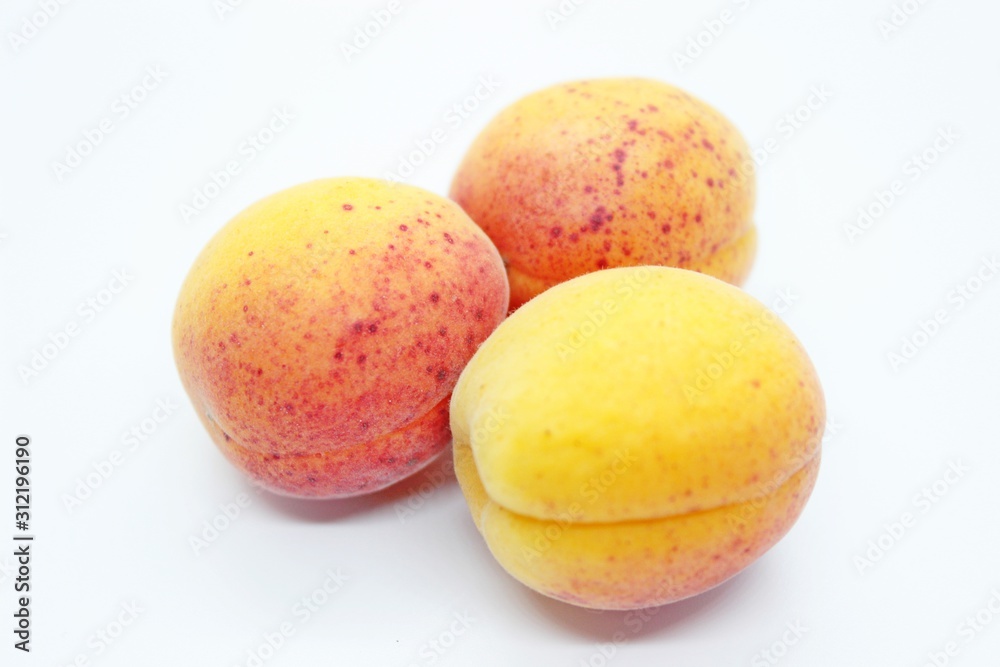 Tasty ripe beautiful apricots located on a white background Tasty ripe beautiful apricots located on a white background