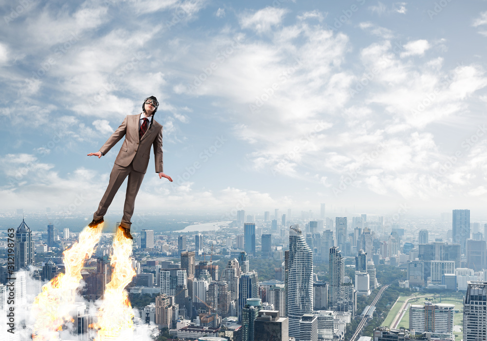 Businessman in suit and aviator hat flying in sky Businessman in suit and aviator hat flying in sky