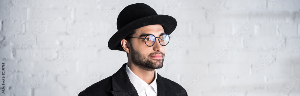panoramic shot of handsome jewish man in glasses looking away panoramic shot of handsome jewish man in glasses looking away