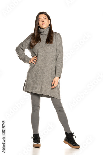 Fotografie Young beautiful woman in gray tunic on white background