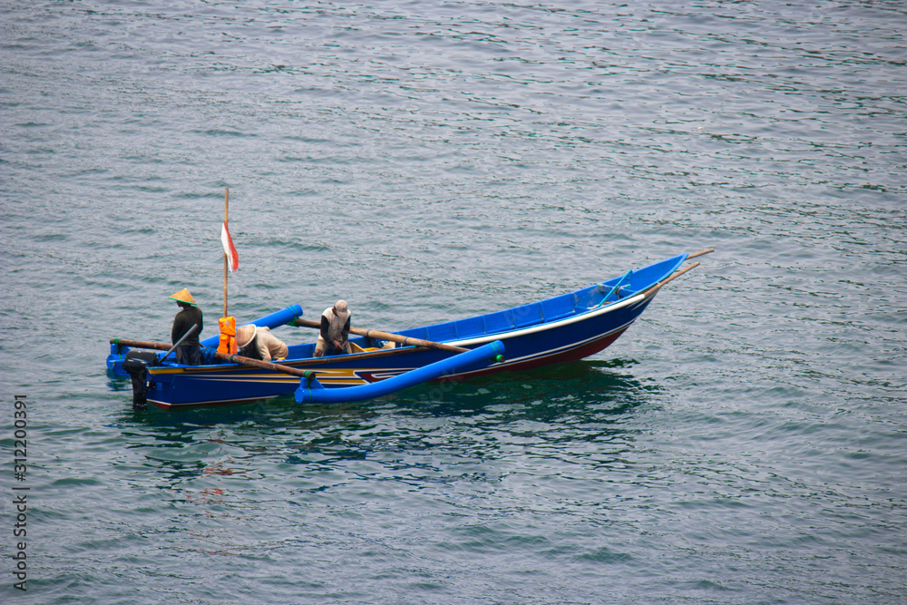 fishermen on a boat, fishing in the middle of the blue sea