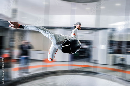 Adrenaline. Extreme sky for free people. No rules in open air. Parachutist in white suit is in free fall. Skydiving is a sport of the future. 