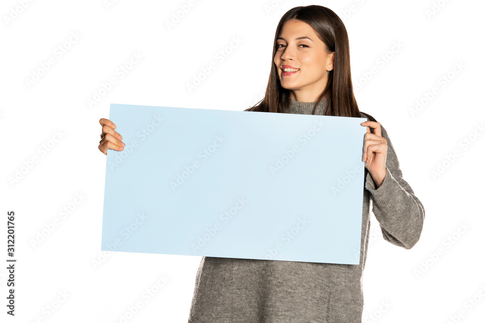 young beautiful happy woman holding a blue empty board on white background young beautiful happy woman holding a blue empty board on white background