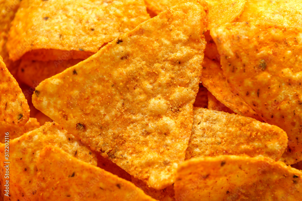 Mexican corn, tortilla cheese chips in a white cup on wooden table