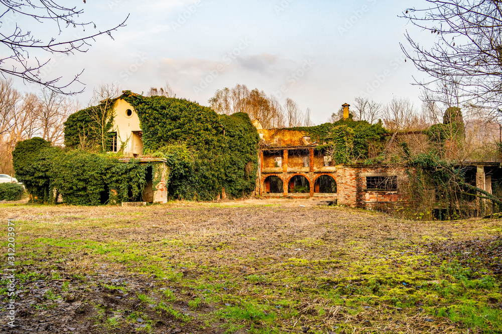 View on an old abandoned and ruined country house View on an old abandoned and ruined country house