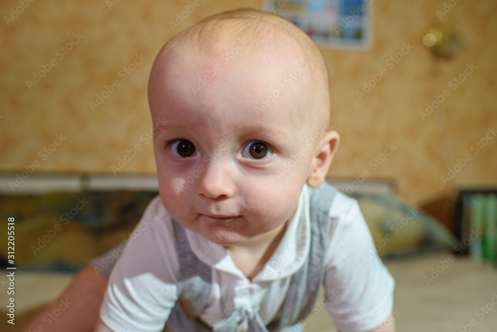 A small child plays on the bed at the parents. Happy childhood. A small child plays on the bed at the parents. Happy childhood.