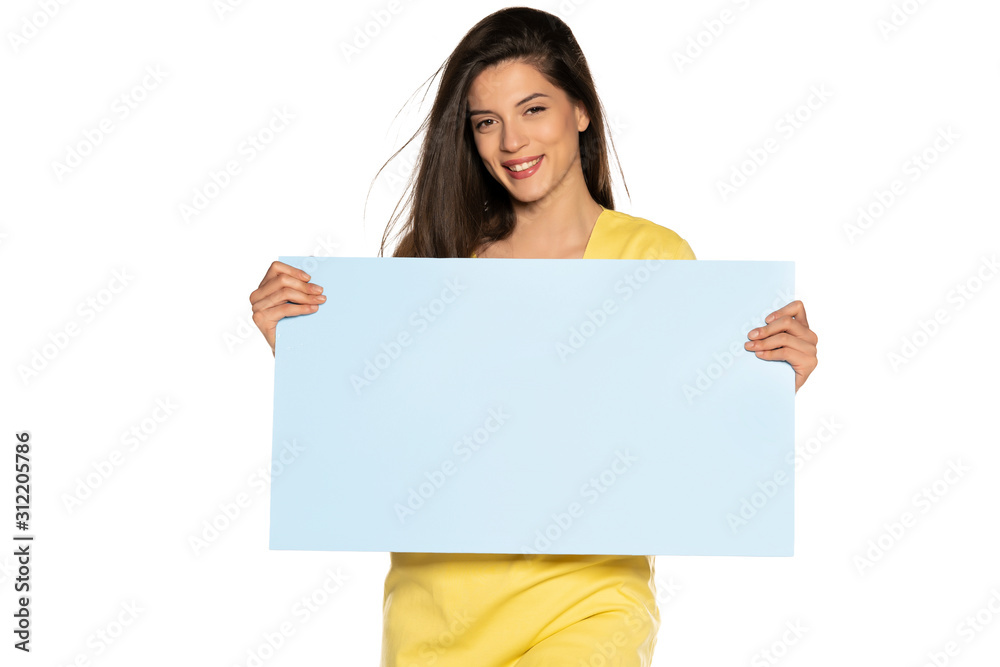 young beautiful happy woman holding a blue empty board on white background young beautiful happy woman holding a blue empty board on white background