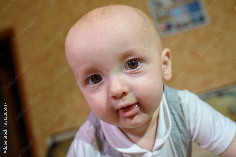 A small child plays on the bed at the parents. Happy childhood.