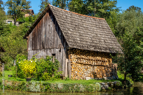 wooden shed with stacked firewood .Rastoke, Croatia.September, 15, 2019