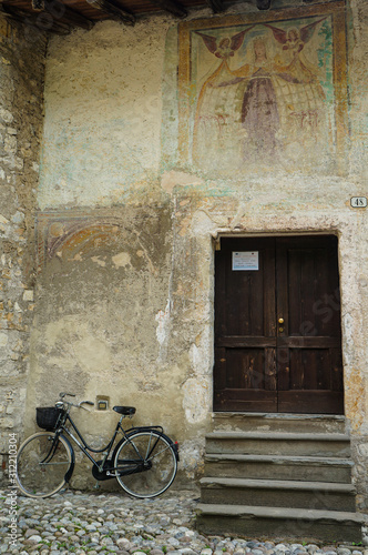 Bicycle parked by a door in Italy