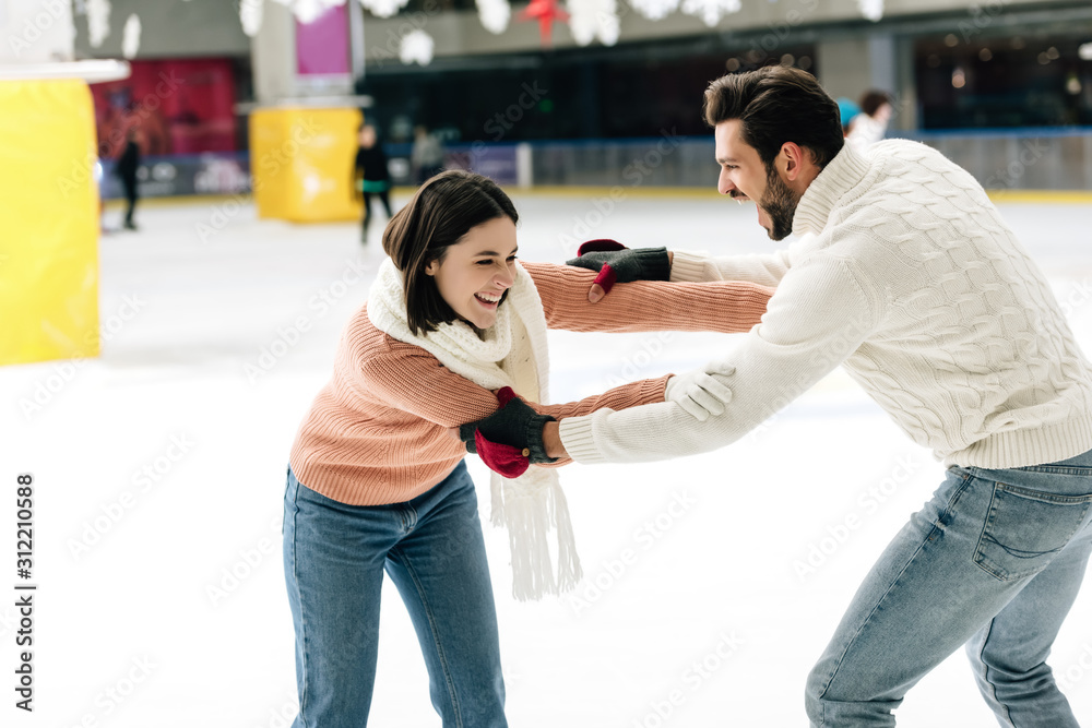 beautiful young couple having fun on skating rink beautiful young couple having fun on skating rink