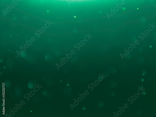 Green bokeh abstract light background. Dark green tones.