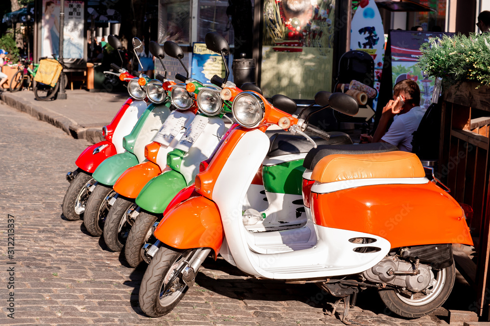 Parking for rental and sale of mopeds, scooters. Row of scooters on the street