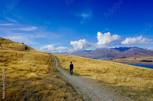 lonely man hiking on mountain road