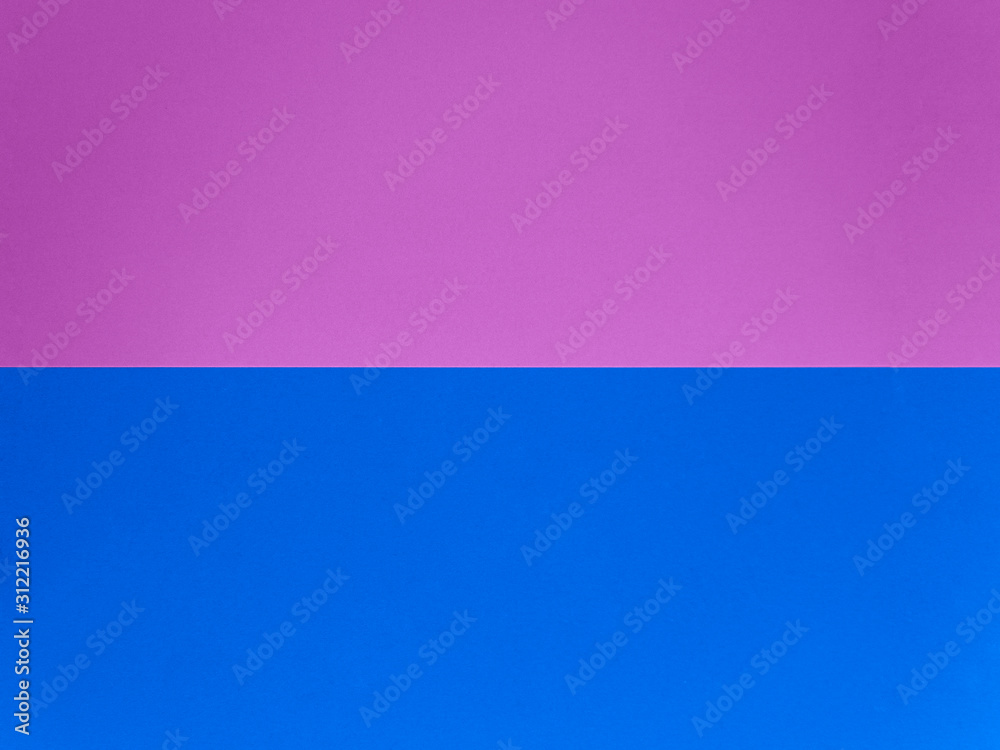 Two trendy colored papers arranged in parallel top view. Pink and blue paper texture abstract background with copy space for your design. Can be used for greeting cards, banners.