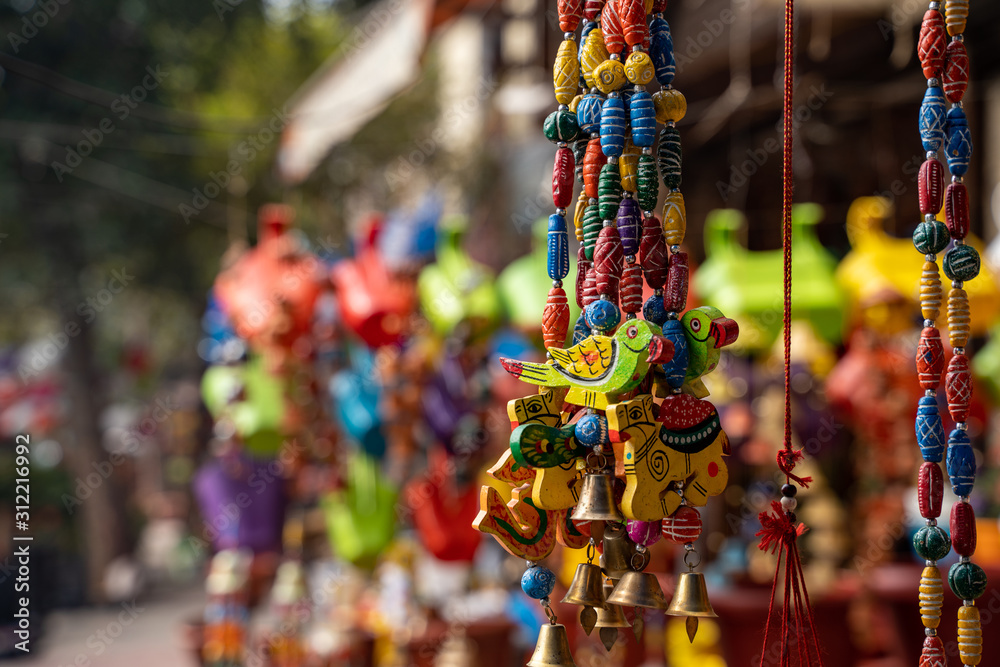 Naklejka premium Decorative hand painted windchimes and hanging decorations at a market in New Delhi India