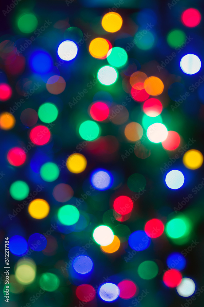 Beautiful bright abstract texture - colorful bokeh. Background for holiday, new year, christmas. Vertical photo