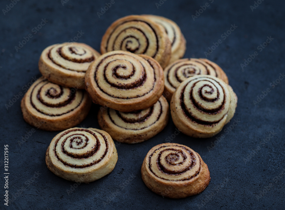 Cookies twisted with cinnamon and milk festive on a dark background, Christmas and New Year