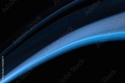 A close up macro photo of a diagonal wisp of blue smoke on a black background that makes an abstract artistic retro background