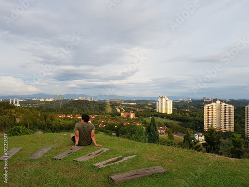 Unidentifiable man taking a rest at a park photo