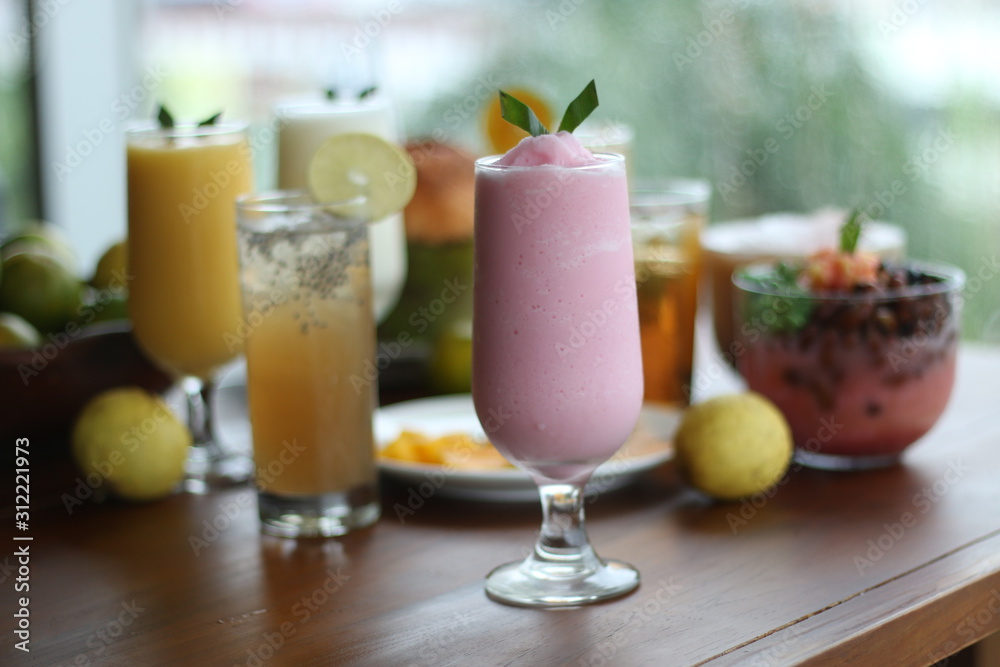 Fresh Juice Orange and Juice Strawberry in a glass Fresh Juice Orange and Juice Strawberry in a glass