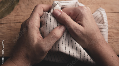 Hands over a wooden background