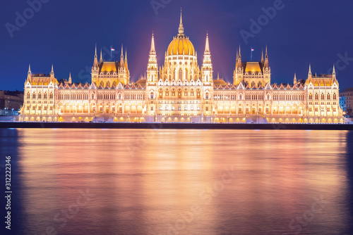 Hungarian Parliament Building on the bank of the river Danube in Budapest at night, aerial photo