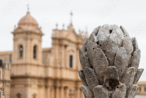 Baroque ornament in Noto (Sicily, Italy); in the background blurred view of the cathedral photo