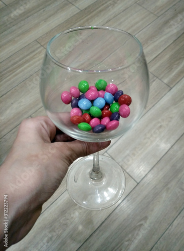 glass of candy in hand