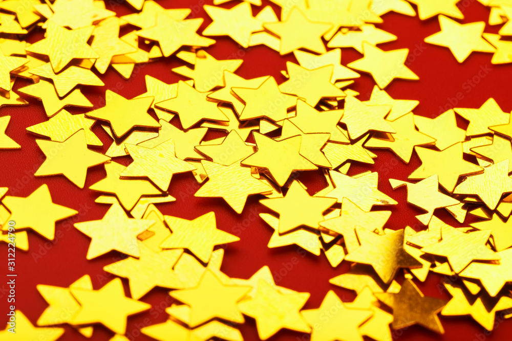 Gold stars on red background. The concept of greeting cards, headlines and web site. A scattering of Golden stars Gold stars on red background. The concept of greeting cards, headlines and web site. A scattering of Golden stars