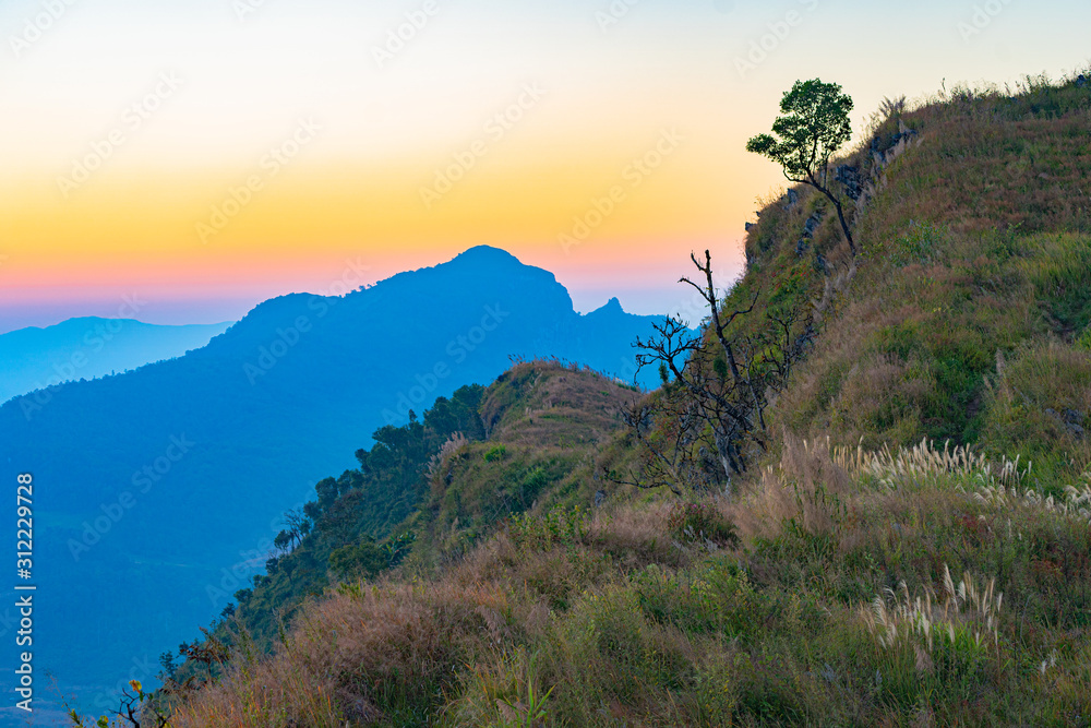 scenery sunrise above the mountain ridge on Doi Pha Phung at Nan province in Thailand.