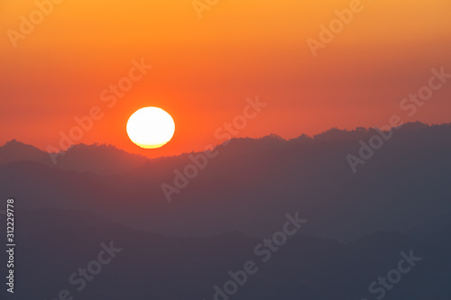 scenery sunrise above the mountain ridge on Doi Pha Phung at Nan province in Thailand. © Narong Niemhom