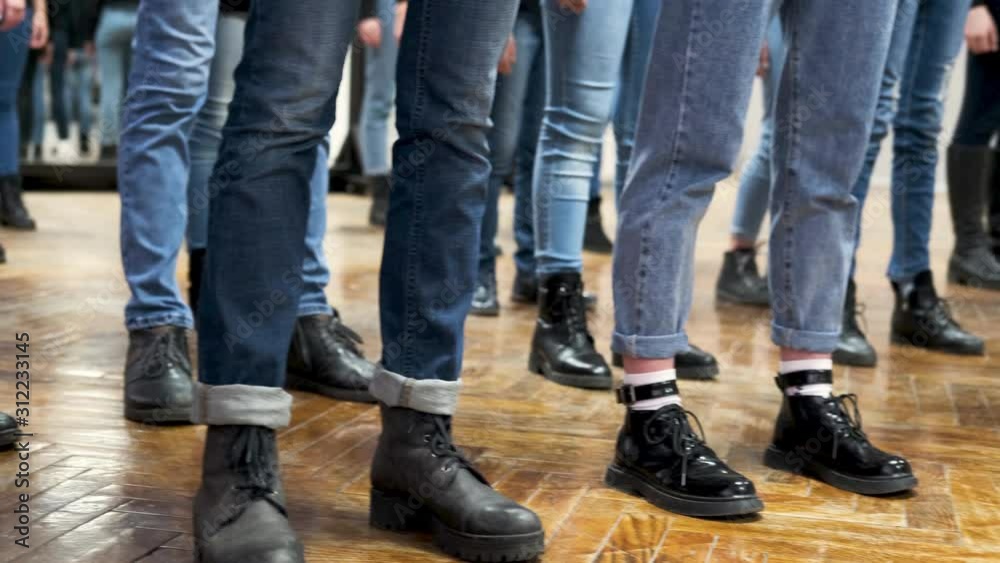 large group of childrens legs in blue jeans and black boots. training large group of childrens legs in blue jeans and black boots. training