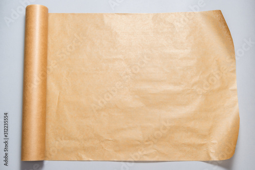 Roll of baking paper on grey background