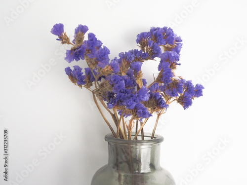 bouquet of flowers in glass vase isolated on white
