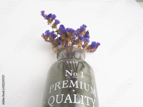 bottle of wine with flowers isolated on white