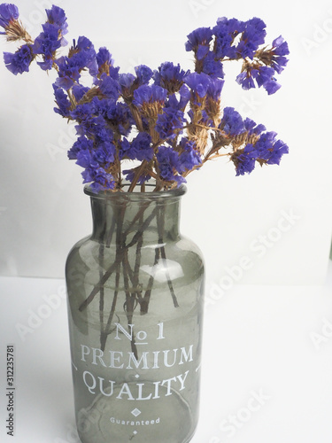 bouquet of flowers in glass vase on white background