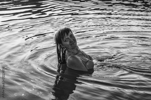 Fototapeta Naklejka Na Ścianę i Meble -  Girl in the water. Splashes, drops and beautiful girl