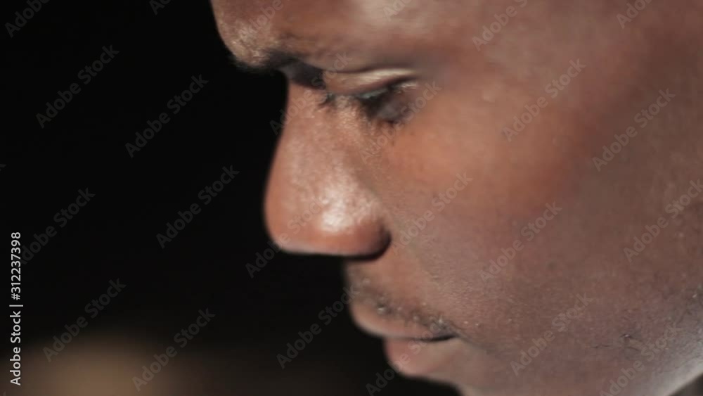 A close up shot of the face of African male student concentrating at school. A close up shot of the face of African male student concentrating at school.