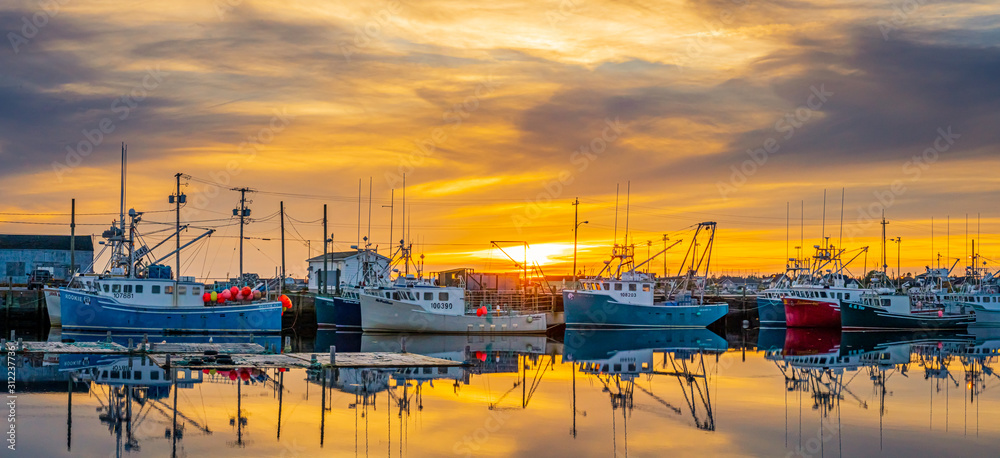 sunset at the wharf where the lobster boats are berthed.
