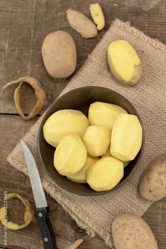 Raw potatoes on wooden table, Top view Raw potatoes on wooden table, Top view