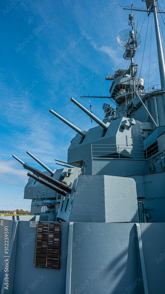 Close up pictures of old WW2 battleship during daytime Close up pictures of old WW2 battleship during daytime