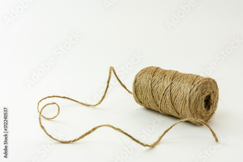 Spool of jute twine isolated on white background.