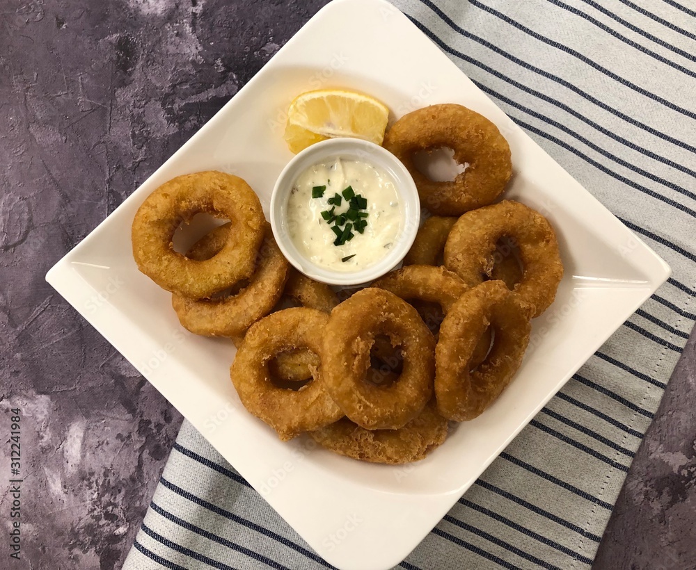 Deep fried Octopus rings with sauce Tartare. Italian food Calamari