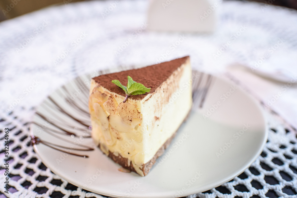 Philadelphia cheesecake on a table in a cozy chocolate bar. Tasty food. Philadelphia cheesecake on a table in a cozy chocolate bar. Tasty food.