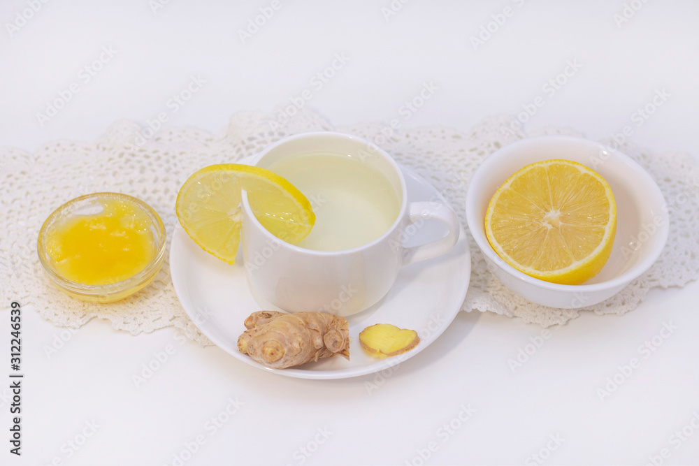 ginger tea with lemon and honey. Tea for immunity, a cold drink. ginger tea in a white cup on a white background. The concept of winter, health, immunity. A healthy detox drink. ginger tea with lemon and honey. Tea for immunity, a cold drink. ginger tea in a white cup on a white background. The concept of winter, health, immunity. A healthy detox drink.