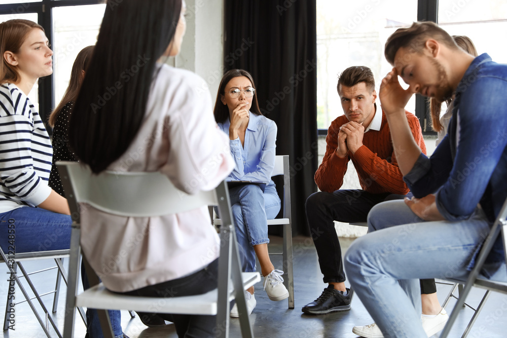 Psychotherapist working with patients in group therapy session indoors Psychotherapist working with patients in group therapy session indoors