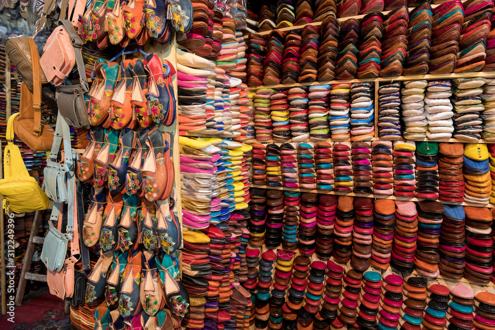 The traditional handmade leather handbag and slippers and other product is displayed in the tannery and showroom in the souk of Fes. Morocco